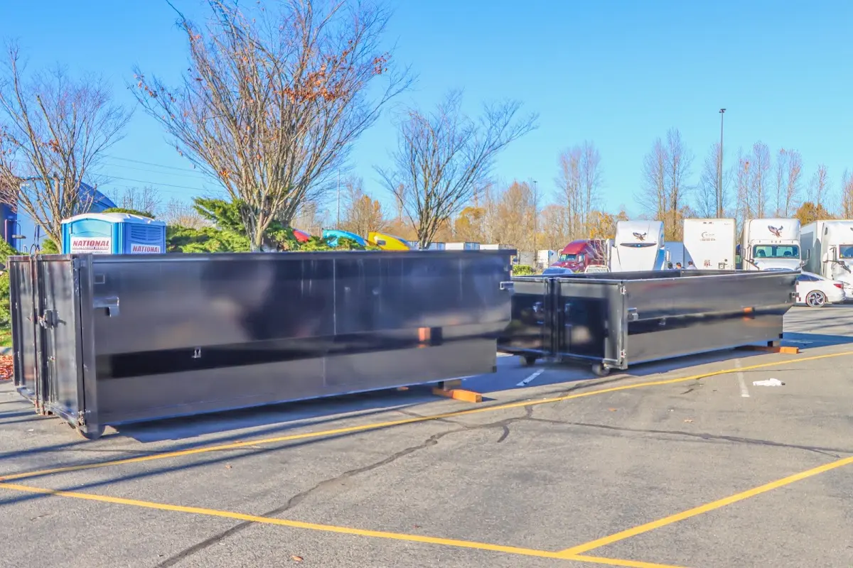 Professional dumpster rental service with roll-off container on residential driveway in Senoia